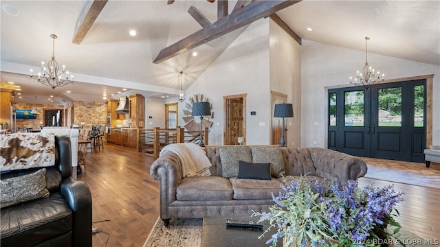 living room featuring beamed ceiling, wood-type flooring, and a chandelier