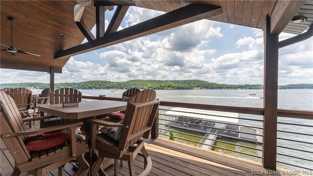 wooden terrace featuring a water view and ceiling fan