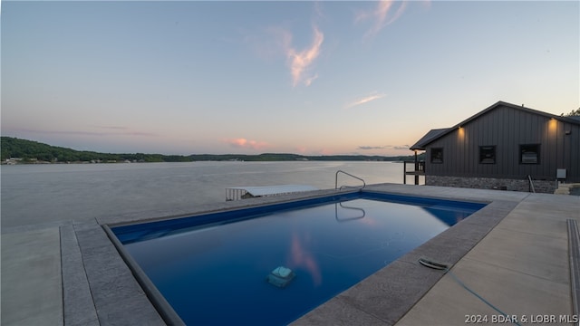 view of pool at dusk