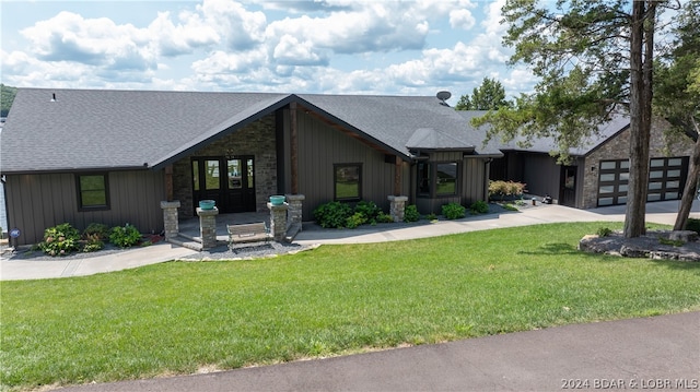 view of front of property with a garage and a front yard