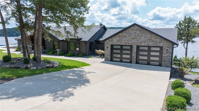 view of front of home featuring a garage and a water view