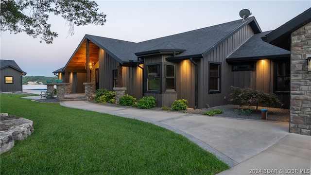 property exterior at dusk with a yard