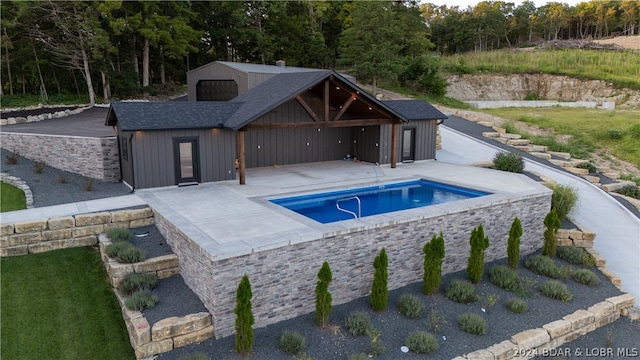 view of pool featuring a patio and a hot tub