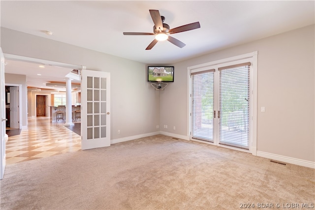 carpeted spare room with ceiling fan