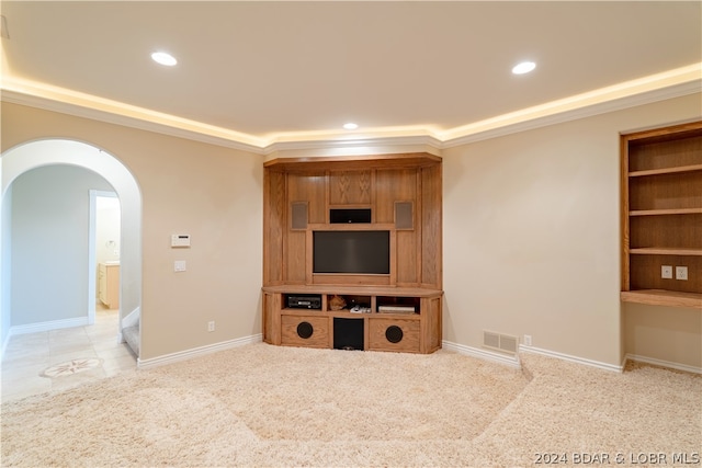 living room with built in features, crown molding, and light colored carpet