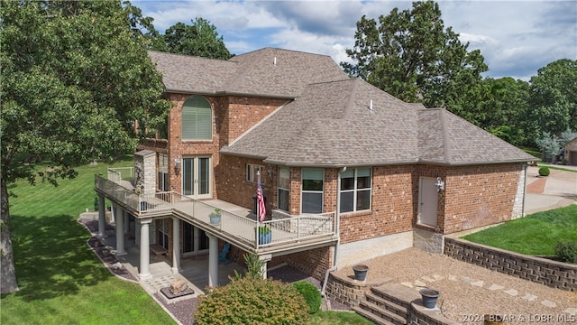 rear view of property featuring a lawn