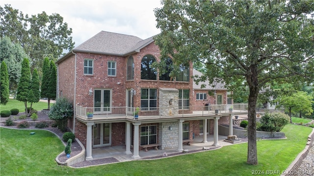 rear view of house featuring a patio area and a lawn