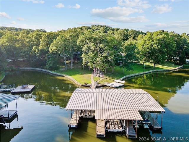 dock area featuring a water view and a lawn