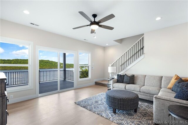 living room with ceiling fan and hardwood / wood-style flooring