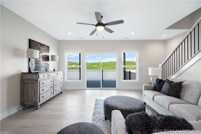 living area with baseboards, light wood finished floors, a ceiling fan, and recessed lighting