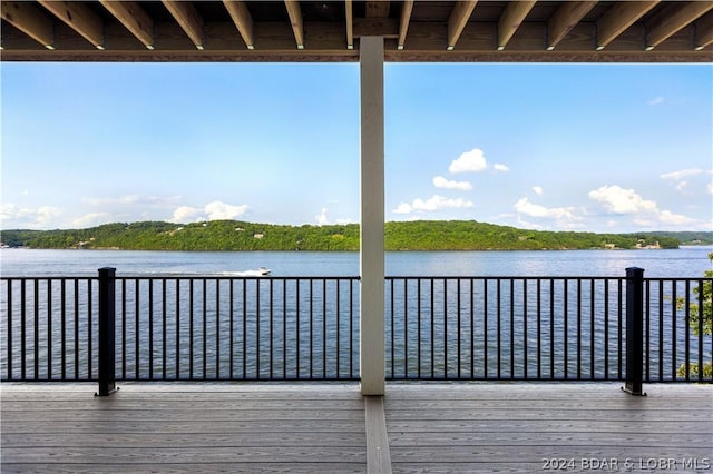 wooden terrace featuring a water view