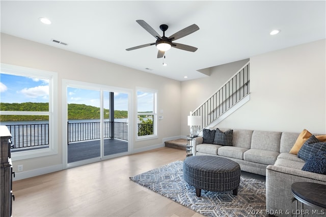 living room with wood-type flooring and ceiling fan