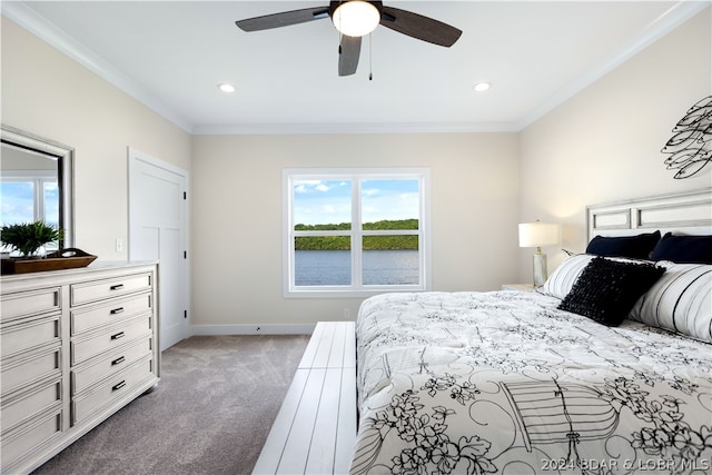 carpeted bedroom with ceiling fan and crown molding