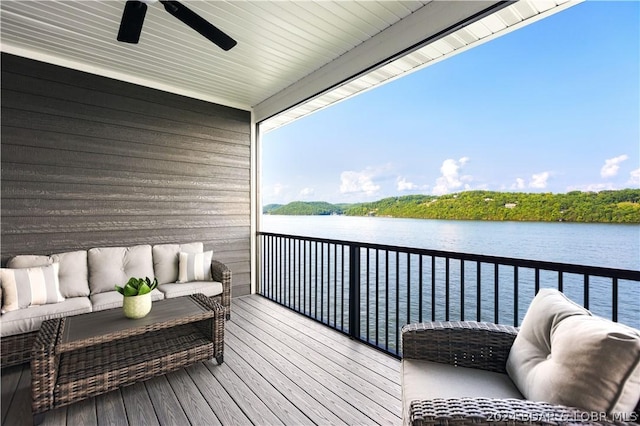 balcony with a ceiling fan, a water view, and outdoor lounge area