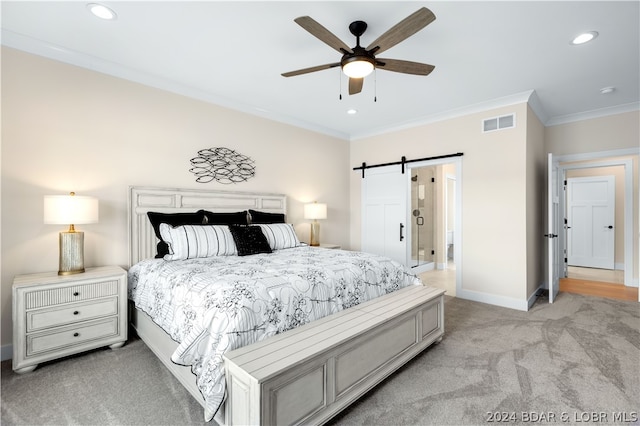 carpeted bedroom with ceiling fan, a barn door, and crown molding