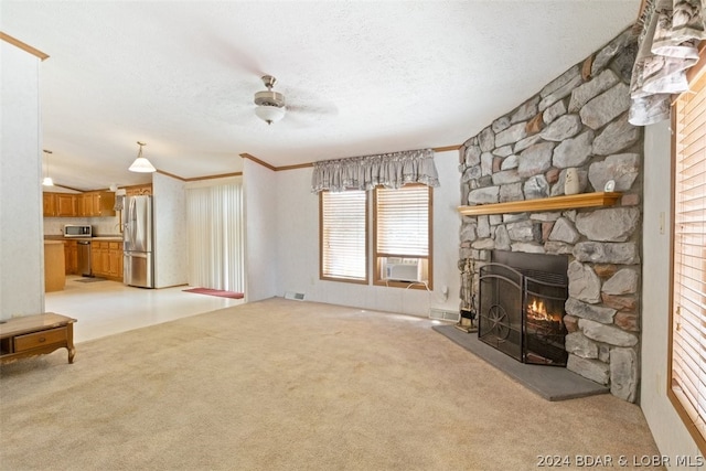 unfurnished living room featuring a fireplace, cooling unit, light colored carpet, ceiling fan, and a textured ceiling