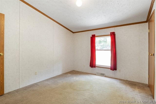 carpeted empty room with a textured ceiling