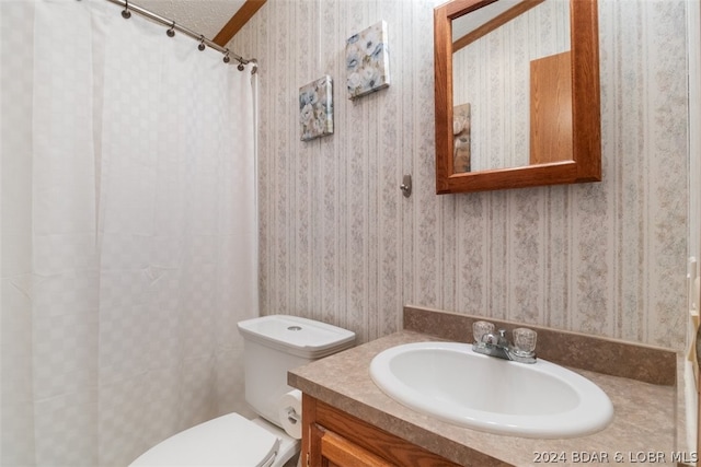 bathroom with vanity, a shower with curtain, a textured ceiling, and toilet