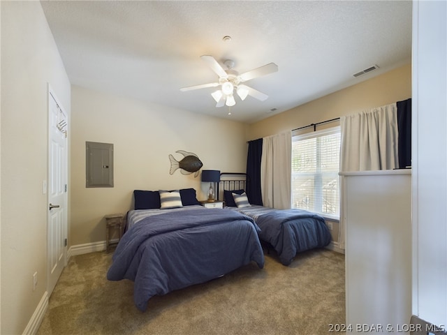 carpeted bedroom with electric panel and ceiling fan