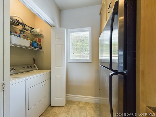 laundry area featuring washer and dryer and light tile patterned floors