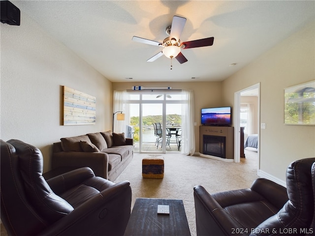 living room with carpet floors and ceiling fan