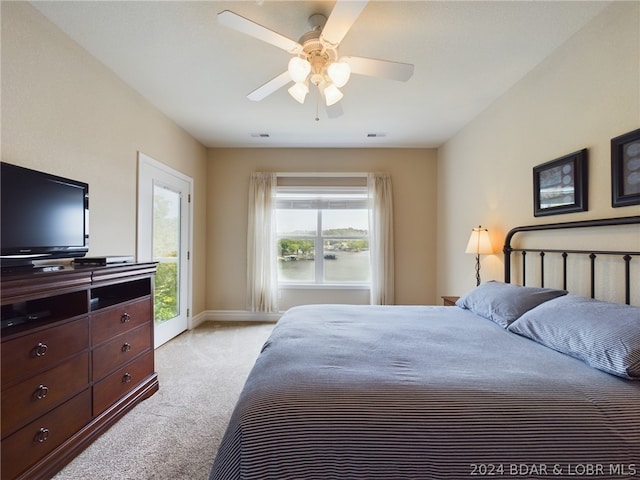 carpeted bedroom with access to exterior and ceiling fan