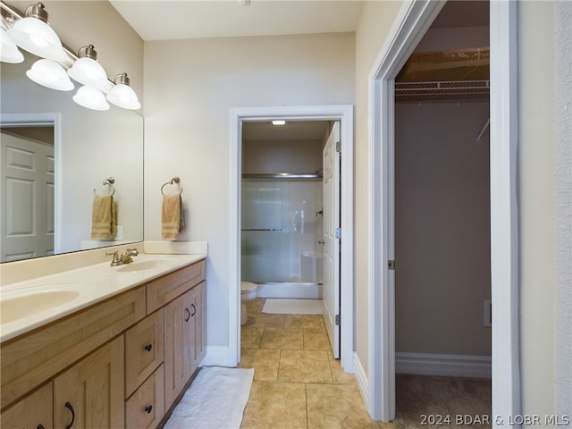 bathroom with vanity, an enclosed shower, tile patterned floors, and toilet