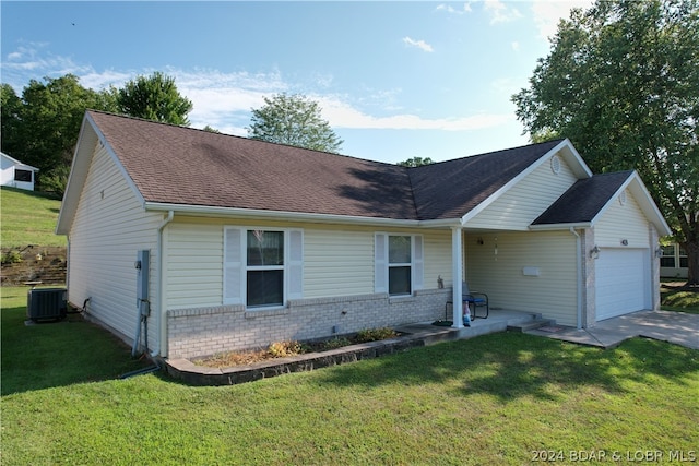 ranch-style house with a garage, a front yard, and central AC unit