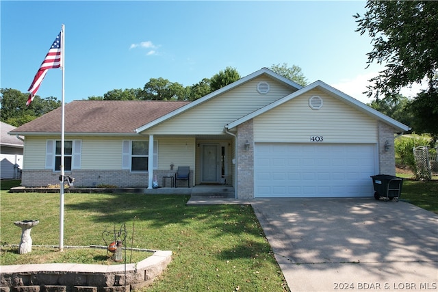 single story home with a garage and a front yard