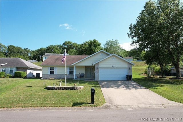 ranch-style house featuring a garage and a front lawn