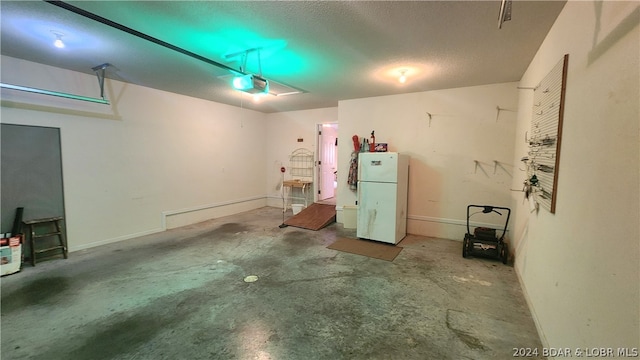 garage featuring a garage door opener and white fridge