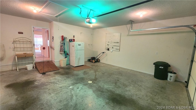 garage with a garage door opener and white fridge