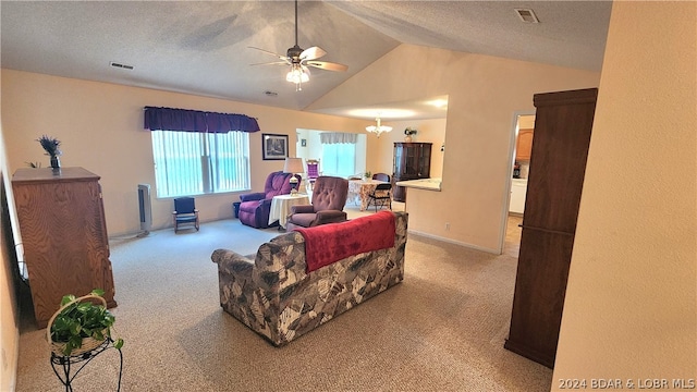 carpeted living room with ceiling fan with notable chandelier, vaulted ceiling, and a textured ceiling