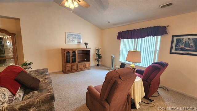 carpeted living room featuring vaulted ceiling