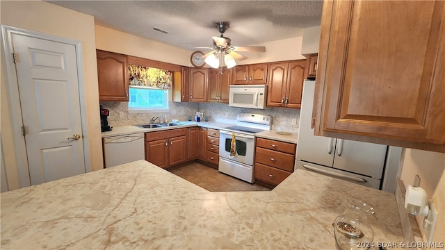 kitchen with tasteful backsplash, sink, white appliances, and ceiling fan