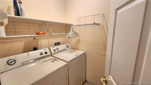 clothes washing area with washing machine and clothes dryer