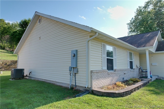 view of property exterior featuring a yard and central AC