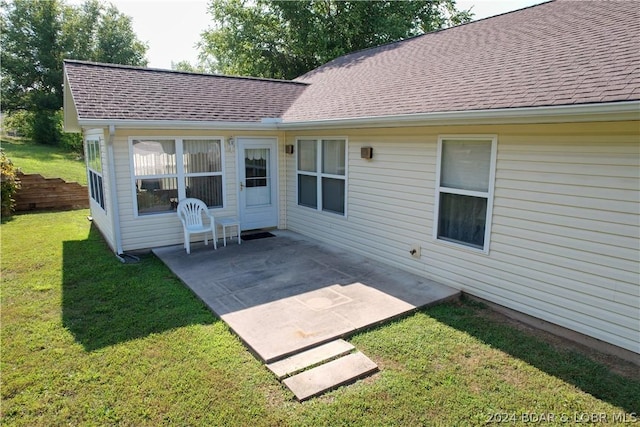 back of house featuring a yard and a patio area