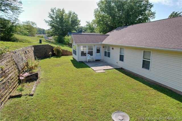 back of house with a patio and a lawn