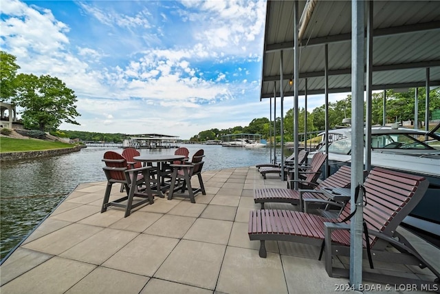 view of patio / terrace featuring a water view and a dock