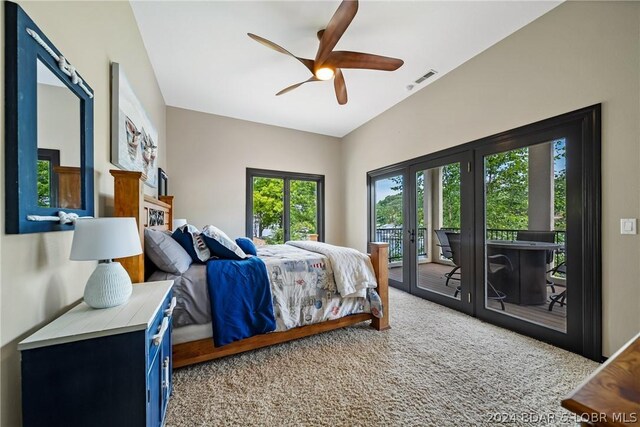 carpeted bedroom with access to exterior, french doors, and ceiling fan