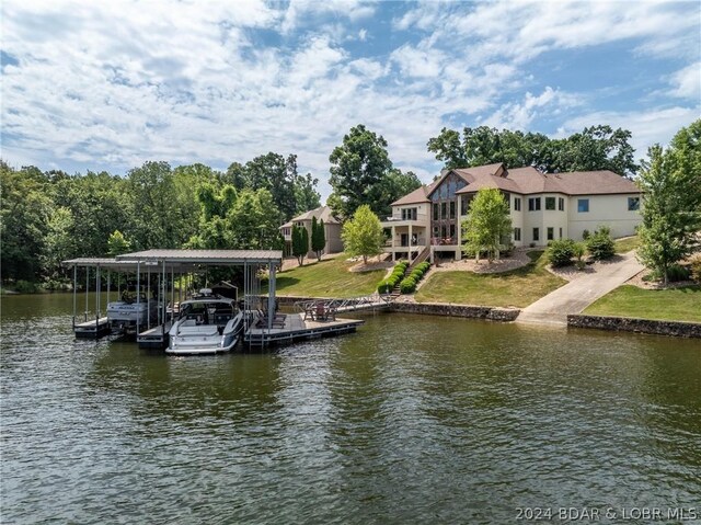 view of dock with a water view and a yard