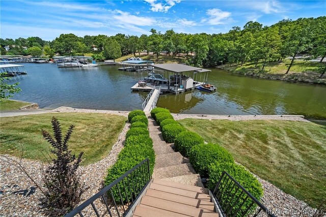 dock area with a water view and a yard