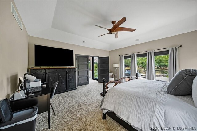 carpeted bedroom featuring ceiling fan, access to exterior, and vaulted ceiling