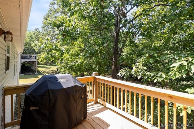 wooden deck featuring area for grilling