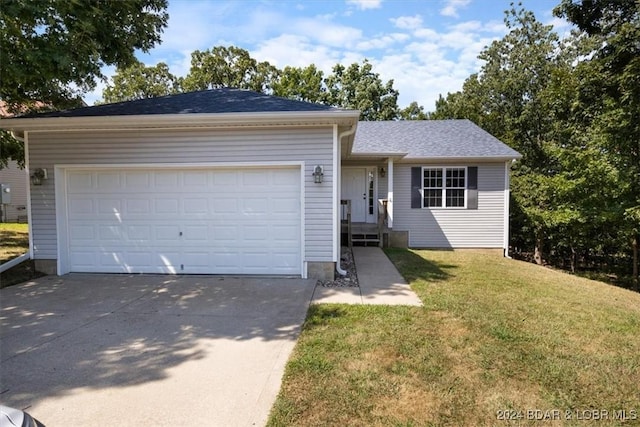 single story home featuring a garage and a front lawn