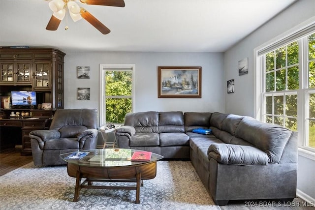 living room featuring hardwood / wood-style floors and ceiling fan