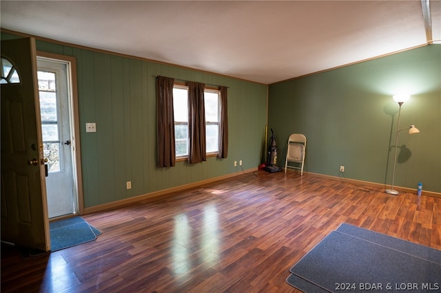 interior space with plenty of natural light, dark wood-type flooring, and ornamental molding