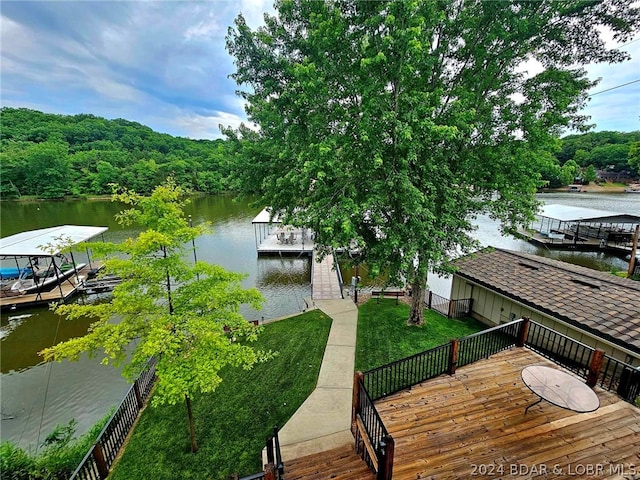 dock area featuring a yard and a water view