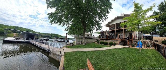 dock area with a water view and a lawn